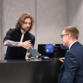 Professional consultation at an official Samsung store: an expert demonstrates the device's features to the customer.